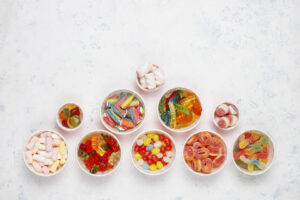 Colorful candies, jelly,marshmallow on light background. Top vie
