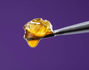 Popular cannabis concentrates in sleek containers, dark background.