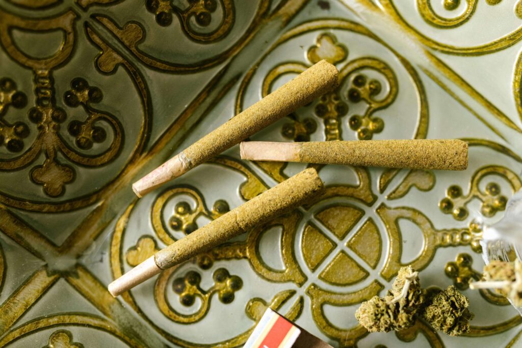 Variety of premium cannabis pre-rolls on wooden surface