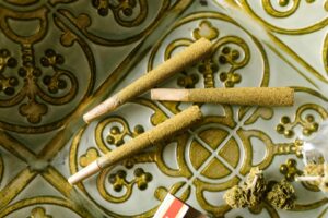 Variety of premium cannabis pre-rolls on wooden surface