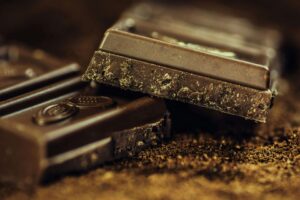 Cannabis-infused chocolate bars with rustic wood background